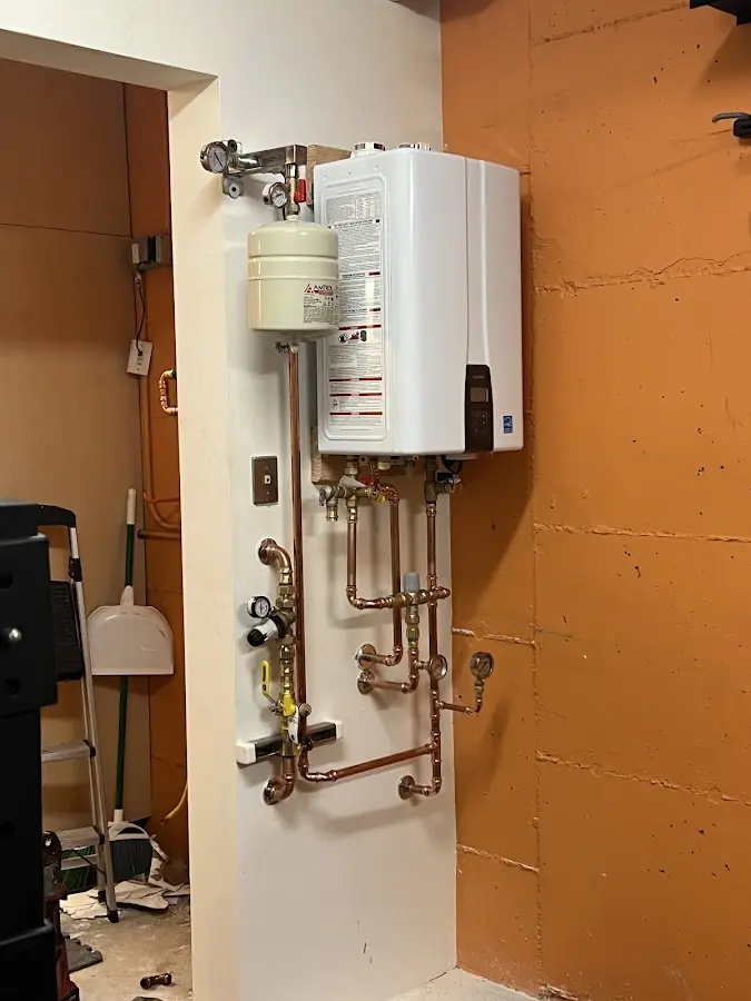 Plumbing technician inspecting water heater connections in Salida